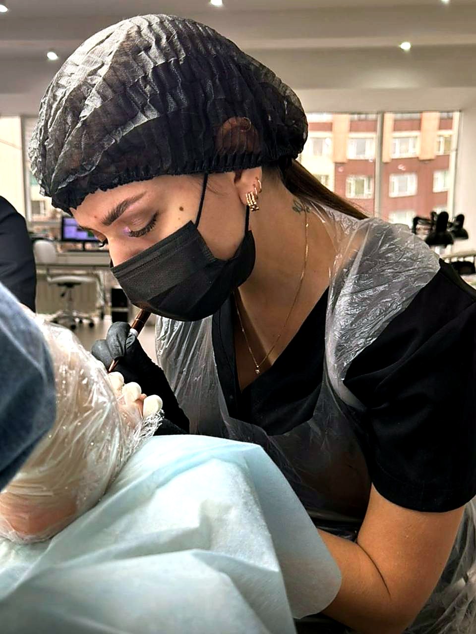 NailInna beauty nail artist carefully working during a manicure appointment